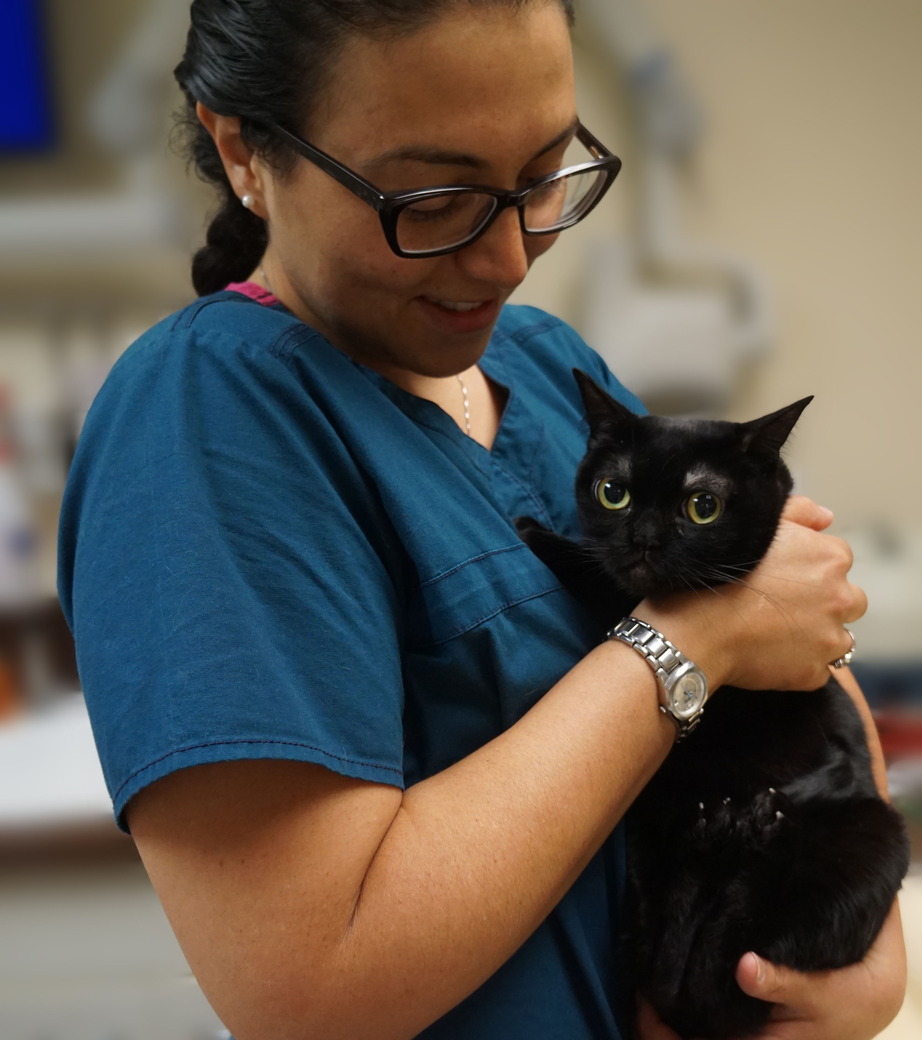 Tracey hugging a black cat.